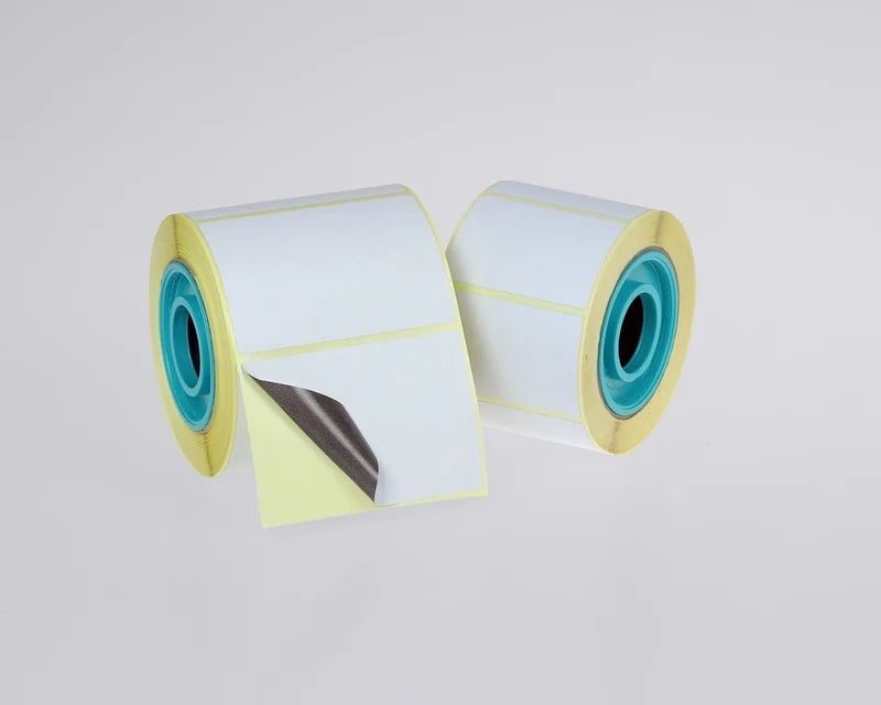Rollen witte correctielabels met dekkende grijze kleeflaag voor het afdekken van oude of foutieve verzendlabels