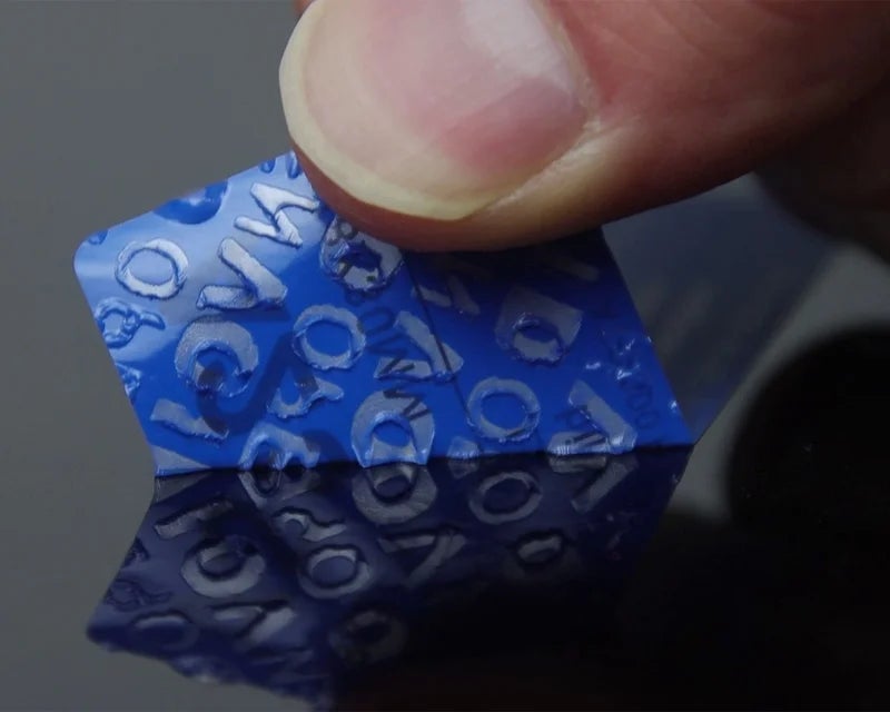 Blauw security label zonder overdracht bij poging tot verwijderen van glad oppervlak
