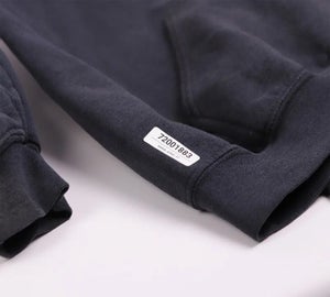 Permanent kledinglabel met unieke identificatiecode aangebracht op de mouw van een donkere trui