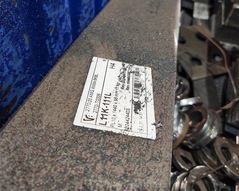 Beschadigd ToughSurface Extreme label aangebracht op ruw metalen oppervlak