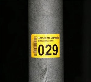 Reflecterend label met nummer op metalen paal voor identificatie in openbare ruimte